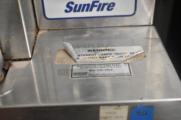 2 Garland SunFire commercial convection ovens, stainless steel, view-through doors, metal racks, thermostatic controls. Warning labels visible.