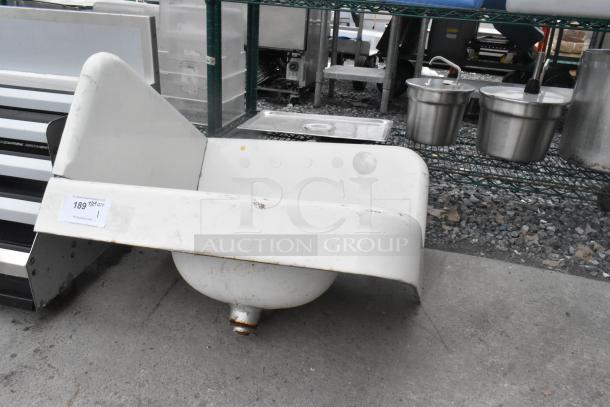 Single bay wall mount sink with two faucets, white finish, some wear visible. Auction tag number 189.