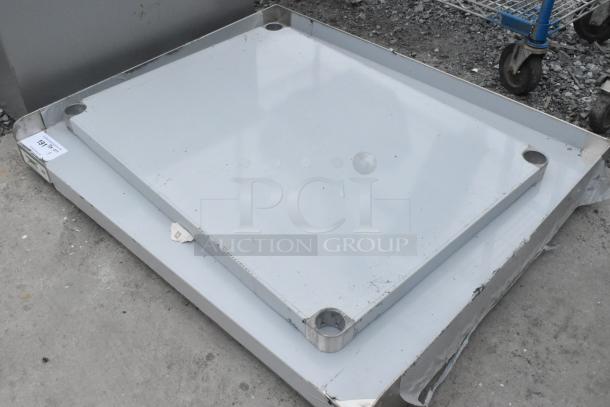 BRAND NEW Regency 600ES3036G 30"x36" stainless steel equipment stand, 16-gauge, no legs, scratch and dent condition.
