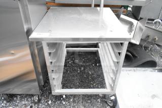 Brand new metal pan rack with minor scratches and dents, on commercial casters. Sturdy construction, ideal for kitchens.
