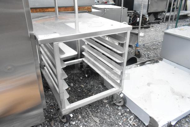 BRAND NEW Metal pan rack with minor scratches, on commercial casters; ideal for storage. Visible label: "104%".