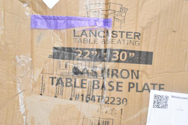 Brand new Lancaster Table & Seating 164TB2230 22" x 30" cross cast iron table base plate box. Visible labels with model details.