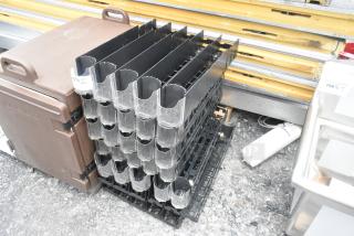 Lot of poly drink sliders, black with clear dividers, stacked in a storage configuration. Quantity and condition tags visible.