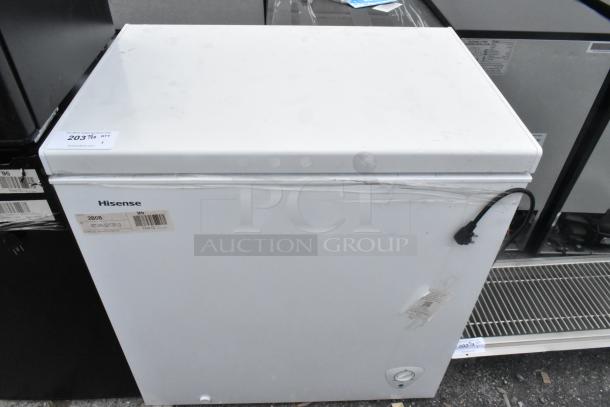 Hisense WFC070M6RWD chest freezer with hinge lid, white finish. Features 115 volts, 1 phase. Visible label with brand and model.