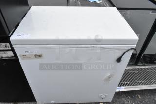 Hisense WFC070M6RWD chest freezer with hinge lid, white finish. Features 115 volts, 1 phase. Visible label with brand and model.