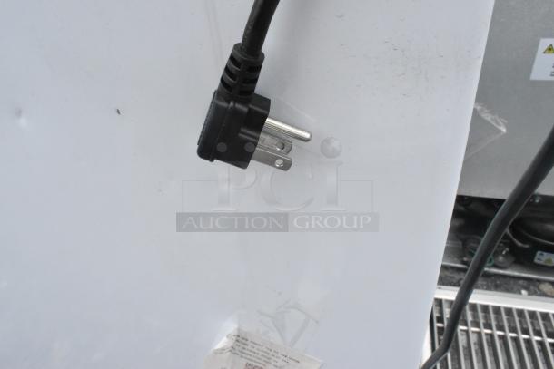 Hisense WFC070M6RWD chest freezer with hinge lid, 115V, 1 phase. Black power plug shown, label partially visible.