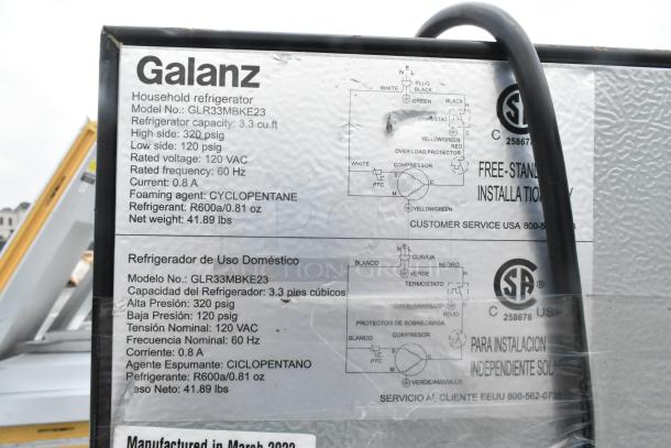 Galanz GLR33MBKE23 mini cooler label showing specs: 3.3 cu.ft capacity, 115 volts, 1 phase. Includes diagrams and certifications.