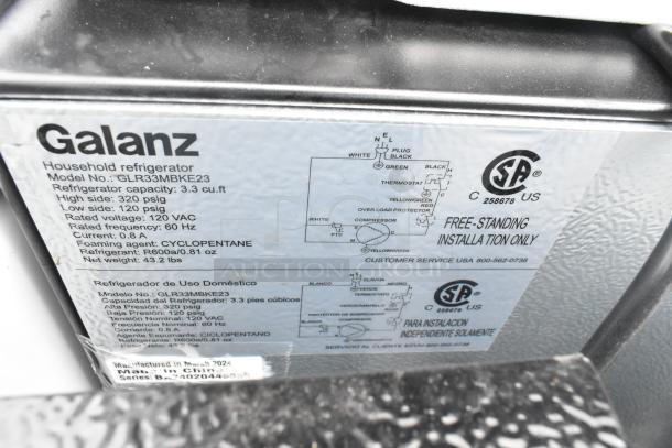 Galanz GLR33MBKE23 mini cooler label displaying specifications: 3.3 cu. ft. capacity, 120 VAC, R600A refrigerant, and installation details.