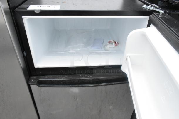 Galanz GLR31TSTE02 Mini Cooler with freezer compartment open, showing interior and label. 115 volts, 1 phase.