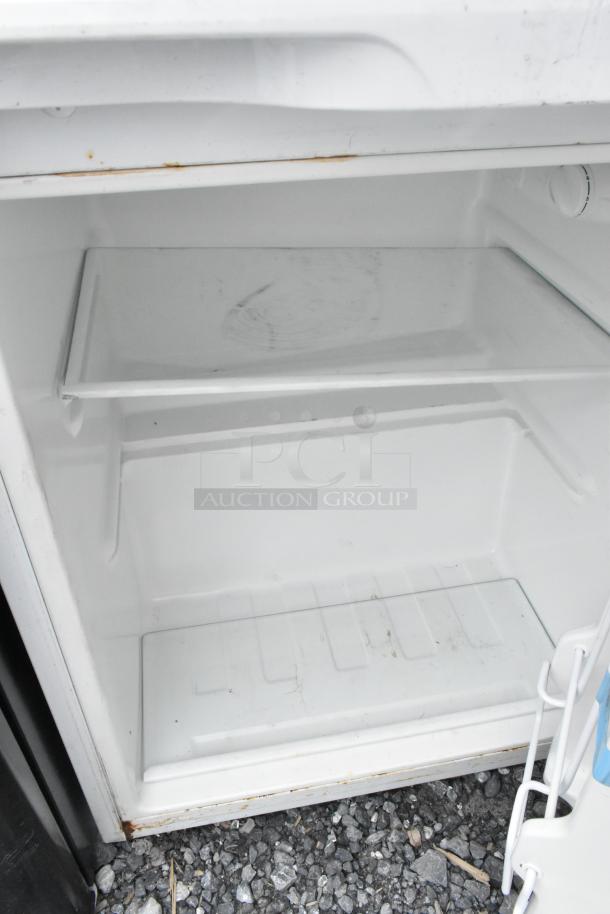 Two mini coolers, brands EdgeStar and Premium. Each is 115 volts, 1 phase. Interior shelf visible; some wear present.