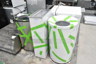 Three brand new scratch and dent trash can shells with green tape markings, varying shapes and sizes.