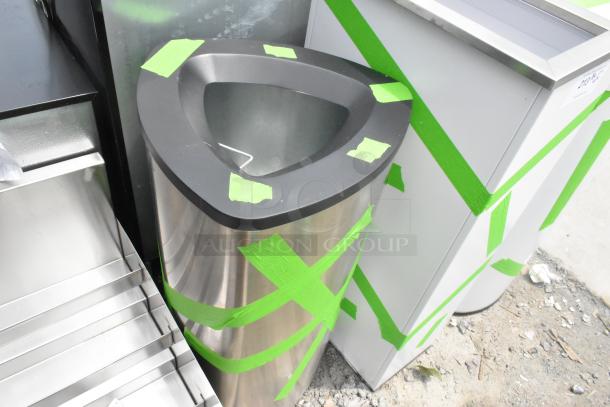 Three brand new stainless steel trash can shells with minor scratches, marked with green tape, modern design.