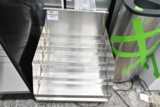 Brand new Regency 600LDR2624 24" five-tier stainless steel liquor display rack, 26" deep, scratch and dent, no legs.