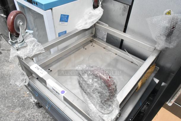 Two stainless steel equipment stands on commercial casters, wrapped in bubble wrap. Durable, mobile, excellent condition.
