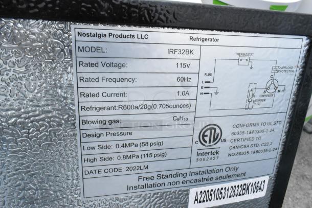 Nostalgia IRF32BK mini cooler label showing model, voltage (115V), frequency (60Hz), and refrigerant (R600a).