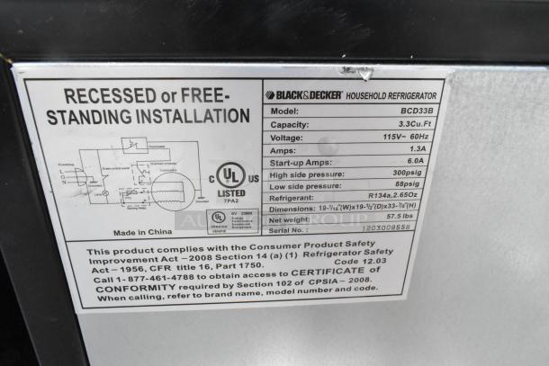 Black & Decker BCD33B mini cooler label showing specs: 3.3 cu. ft. capacity, 115V, 1.3A, R134a refrigerant. Made in China.