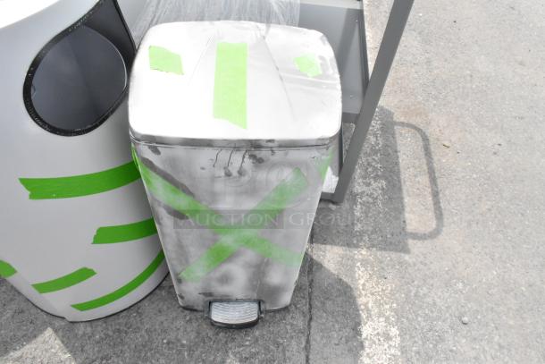 Three assorted trash can shells, metal and plastic, with visible green tape markings, showing signs of wear and weathering.