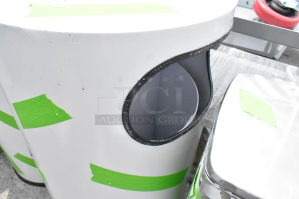 Three white trash can shells with green tape markings, oval opening, minor wear. Auction item: 3 times your bid.