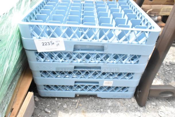 Lot of 4 blue poly dish caddies, brand new with minor scratches. Features tag indicating lot number and quantity. Ideal for dish storage.