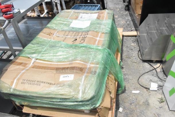 Brand new Regency 600TSB3048S 30"x48" stainless steel table, 16-gauge, with 4" backsplash and undershelf, in packaging.