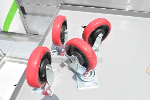 Gray metal 3-tier cart with commercial red casters shown. Brand new, scratch and dent condition.