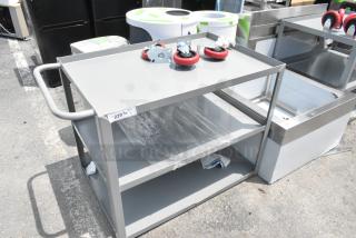 Brand new gray metal 3-tier cart with commercial casters; slight scratches and dents. Includes label with '229/1' marking.