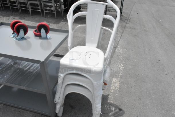 Stack of three brand new white metal Tolix-style chairs, minor scratches visible, labeled "230 x 5."