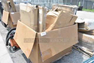 Box of 7 brand new scratch and dent items, including patio tables, partially opened. Labels indicate mixed contents.