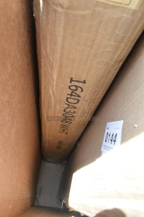 Cardboard box labeled "164DA3048 WHT" with visible scratch and dent, containing patio tables. Auction ID 0144.