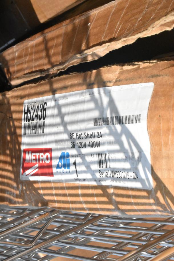 Cardboard box labeled "Metro HS2436." Contains SE Hot Shelf 24, 36 120V 400W. Part of a 12-piece mixed item lot.