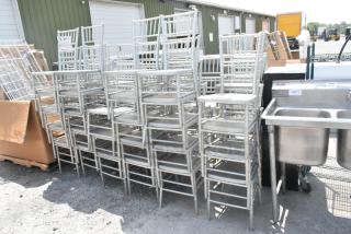 50 light gray Chiavari stackable banquet chairs, suitable for events, in used condition. Auction includes 50 chairs per bid.