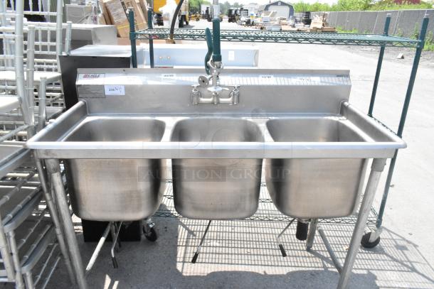 Eagle stainless steel 3 bay sink with faucet and handles, clean condition, includes integrated backsplash and adjustable legs.