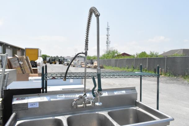 Eagle stainless steel 3-bay sink with faucet and handles, industrial setting, visible labels, good condition.