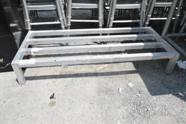 Metal Dunnage Rack with a sturdy, open slat design. Silver finish, used condition, label shows "239" and "FOH DUNAGE RACK."