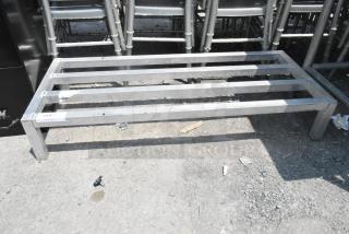 Metal Dunnage Rack with a sturdy, open slat design. Silver finish, used condition, label shows "239" and "FOH DUNAGE RACK."