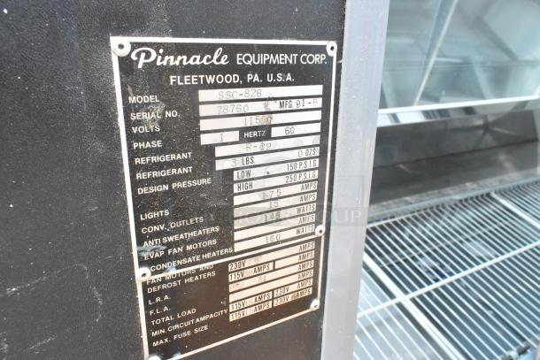 Pinnacle SSC-826 metal deli display case, 115 volts, 1 phase. Model and specs label visible.
