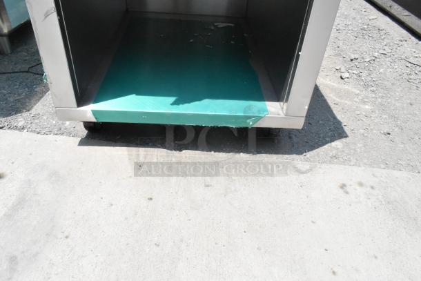 Stainless steel counter with visible drawer, under shelf, and caster wheels, showcasing durability and versatile storage.