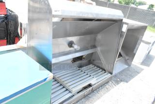 5' stainless steel grease hood with filters and light, used condition; includes visible mounting brackets and light fixture.