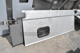 Two gray swinging kitchen doors with small windows, visible scuff marks, and a metal hinge mechanism. Label reads "246th QTY 2".