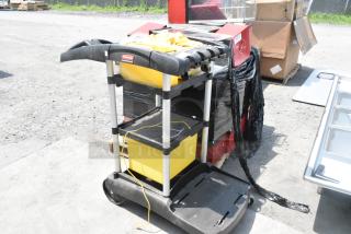 Rubbermaid Poly Janitor Cart with bag holder and shelves, black and yellow, good condition, visible branding.