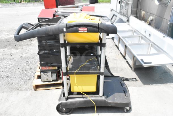 Rubbermaid Poly Janitor Cart with yellow vinyl bag, shelves, and wheels. Used, durable design, ideal for cleaning tasks.