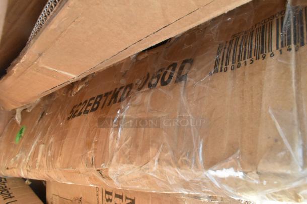 Cardboard box labeled "522EBTKD360D" with visible scratches and dents, containing new items like an ingredient bin and stainless steel table.