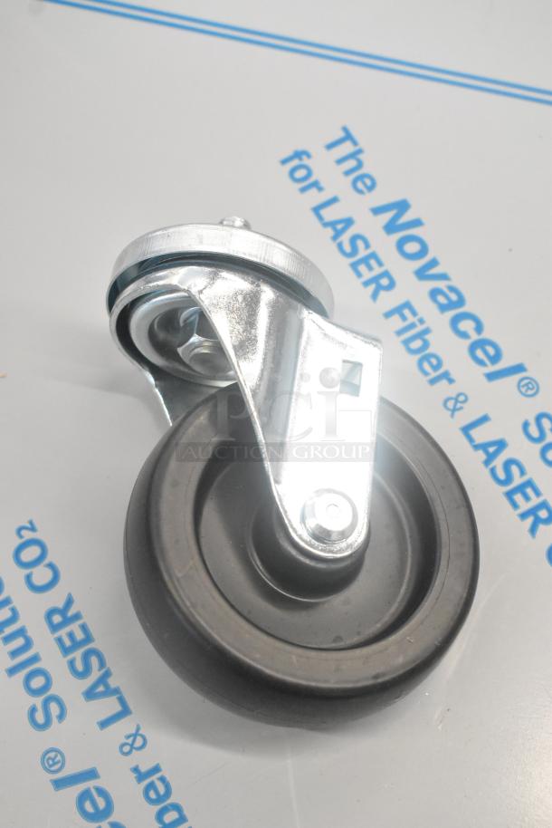 Lot of commercial casters and hose, featuring sturdy black wheel and metal bracket, suitable for industrial use.