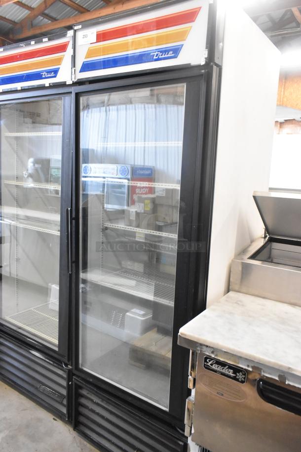 True GDM-23F single door cooler merchandiser, glass front, metal frame, poly coated racks, 115V, clean condition.