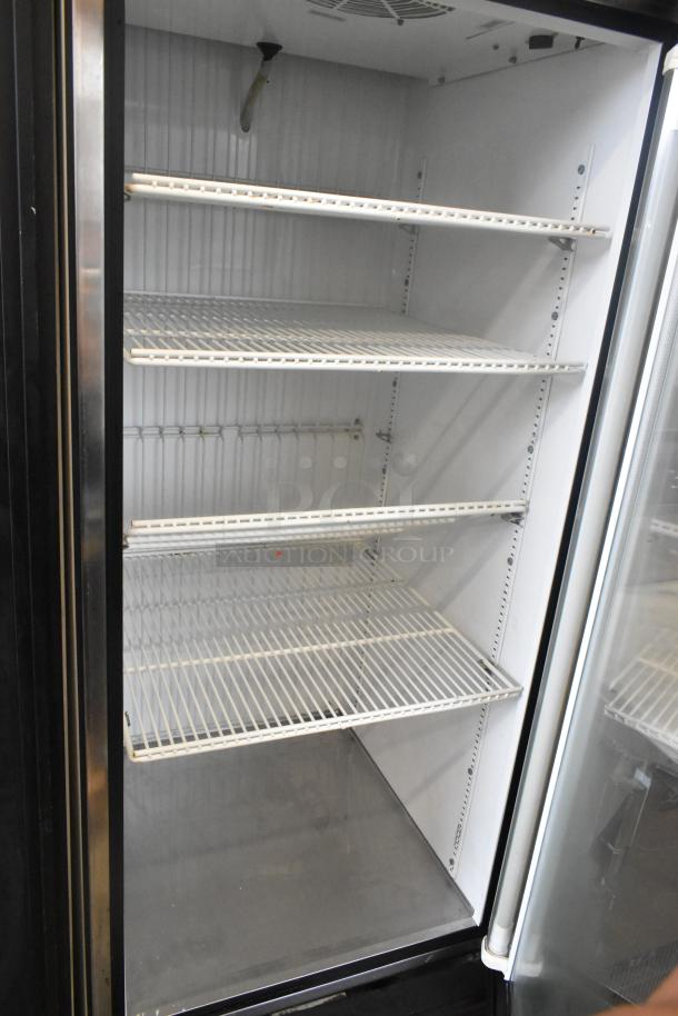True GDM-23F metal single door reach-in cooler with poly-coated racks, 115 volts, 1 phase. Clean interior, good condition.