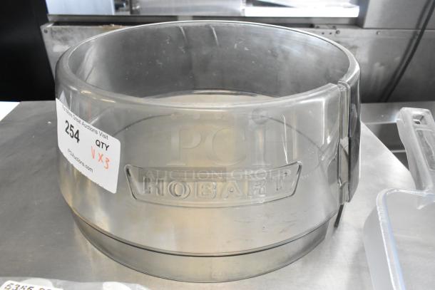 Hobart mixing bowl collar, clear, with auction tag 254, used condition. Includes poly condiment bottle lids and ice scooper.