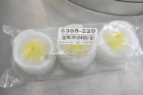 Set of three 5355-220 poly condiment bottle lids, sealed in packaging. Features medium flow valve, NSF certified.