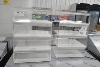 2 clear poly countertop dry display case merchandisers with three shelves each, ideal for showcasing products.