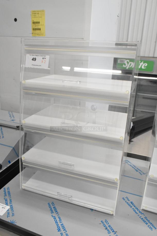Clear poly countertop dry display case with four shelves, excellent condition, perfect for merchandise showcasing. Quantity: 2.