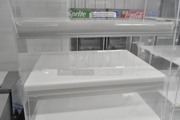 2 clear poly countertop dry display cases, pristine condition, durable polycarbonate, ideal for showcasing merchandise.